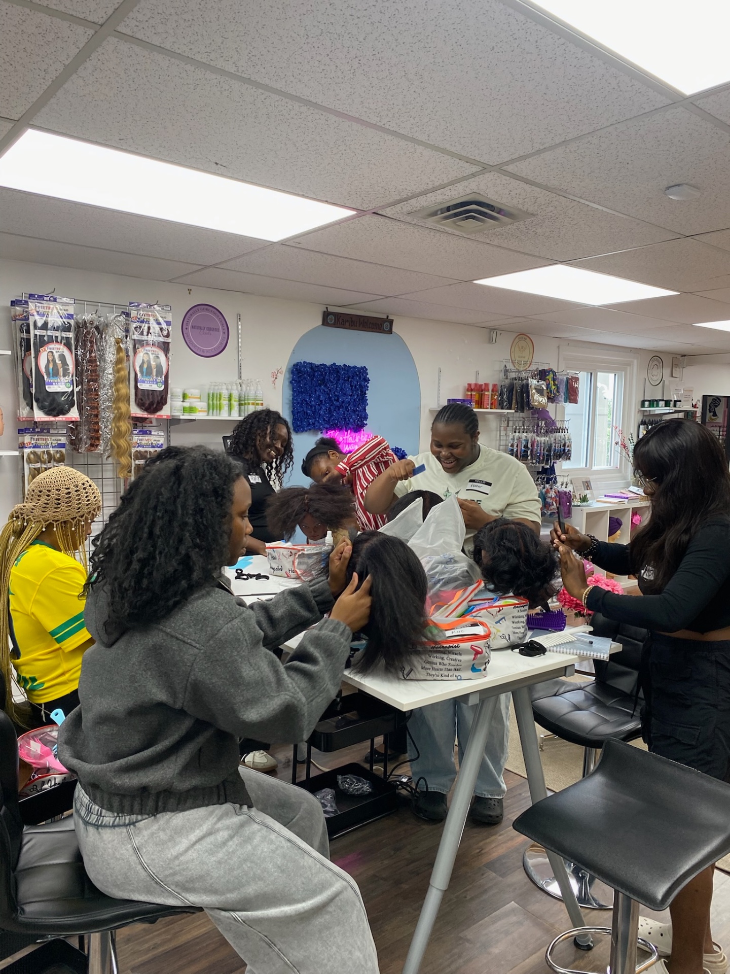 Hairbru students in a hands-on wig styling workshop