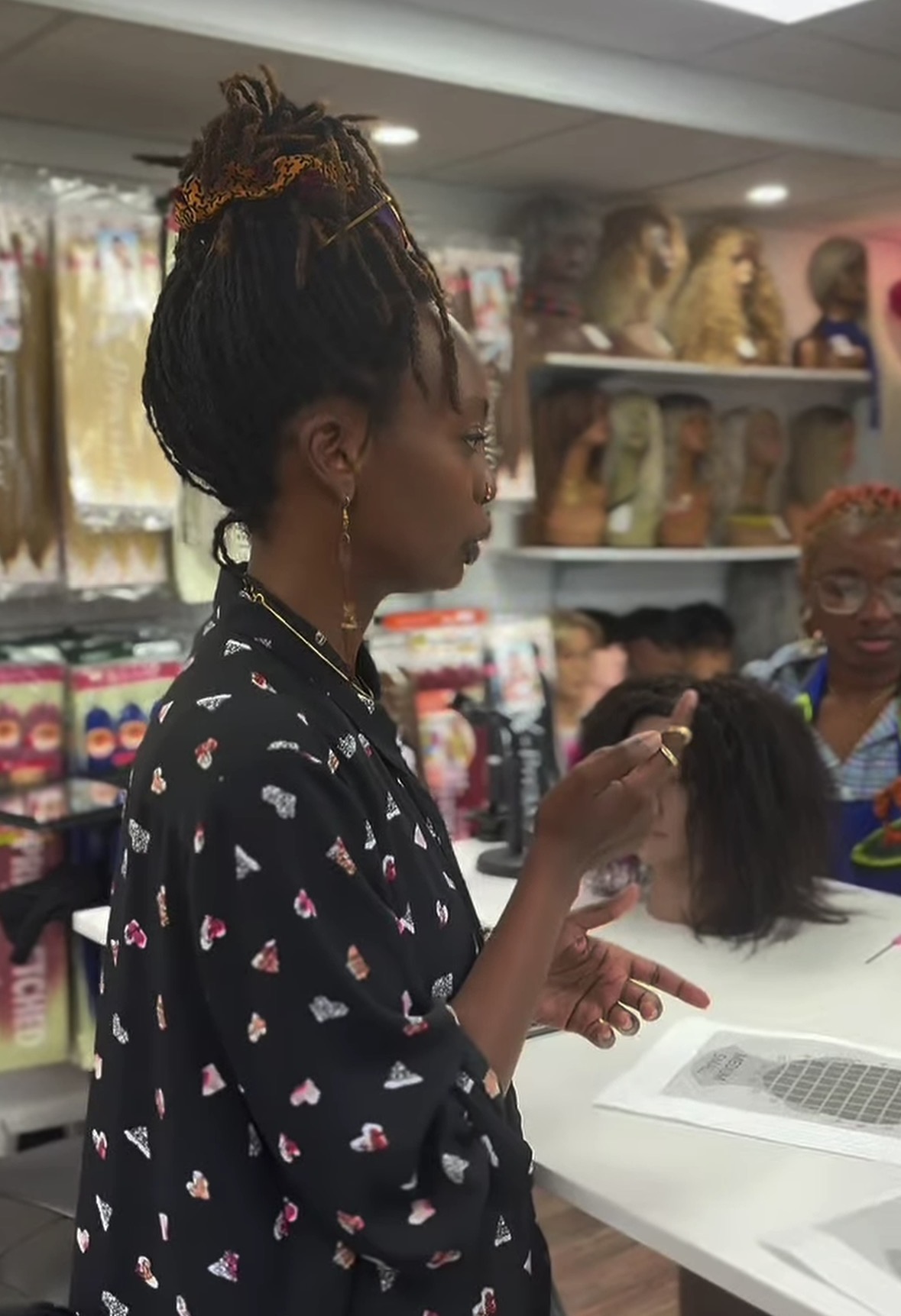 Lead instructor teaching wig construction